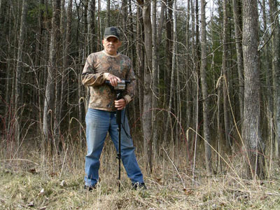 Dallas Gilbert standing in the woods during Bigfoot research